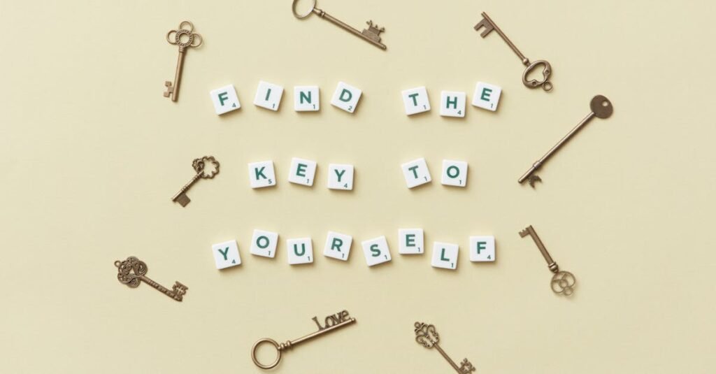 Creative arrangement of vintage keys and motivational text 'Find the key to yourself'.